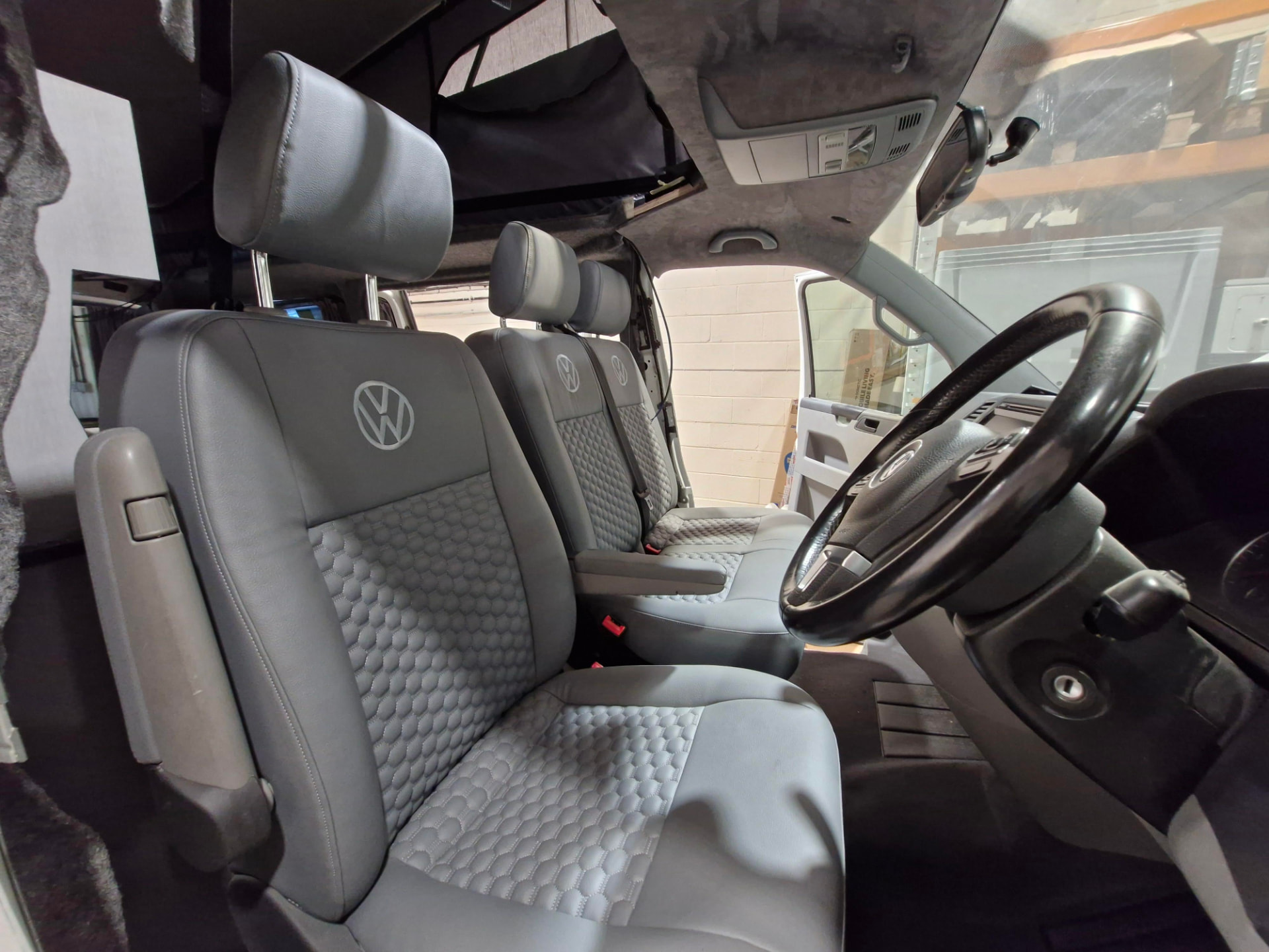 Retrimmed VW Transporter cab seats in grey leather with hexagonal quilted centre panels