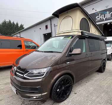 VW Transporter fitted with a Skyline elevating roof, raised with canvas windows open
